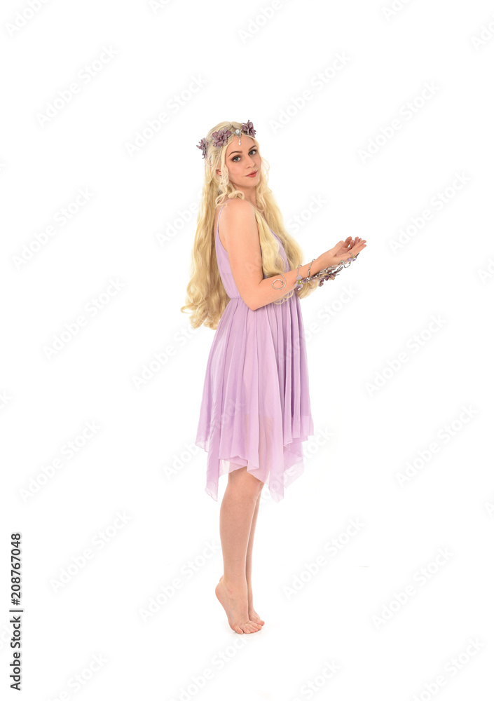 full length portrait of pretty blonde girl wearing purple fairy dress. standing pose, isolated on white studio background. full length portrait of pretty blonde girl wearing purple fairy dress. standing pose, isolated on white studio background.