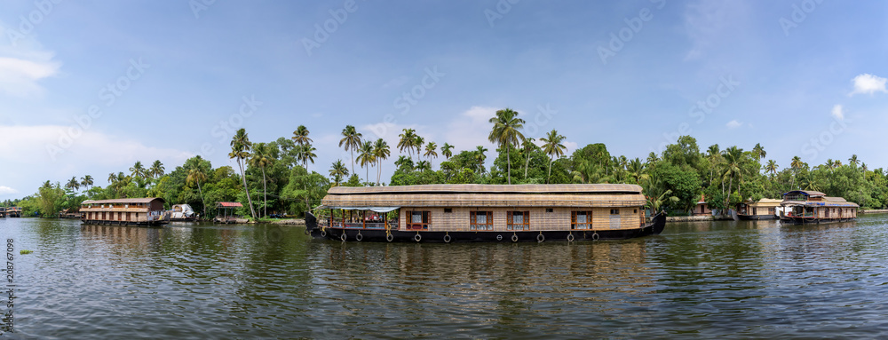 Panoramic river view and traditional house boat in Kerala's Backwaters, India. Panoramic river view and traditional house boat in Kerala's Backwaters, India.