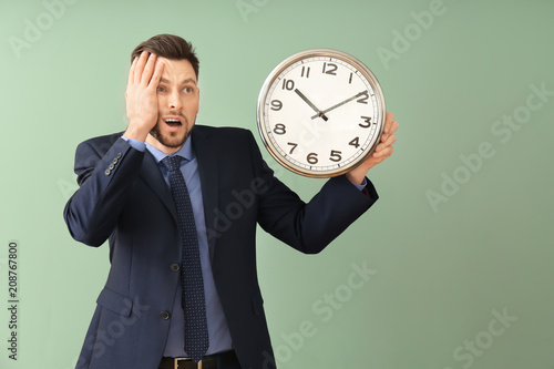 Businessman with clock on c...