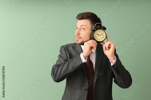 Businessman with alarm cloc...