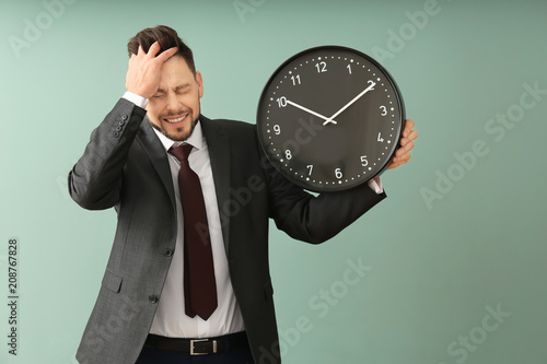 Businessman with clock on c...