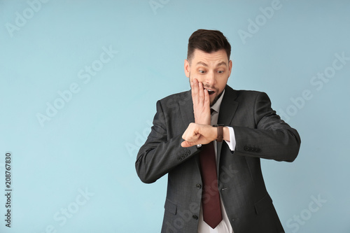 Man looking at wristwatch o...