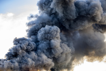 Huge black smoke cloud from fire