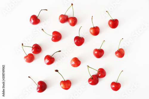 Summer fruit pattern. Healthy fresh red cherries isolated on white table background. Food pattern. Modern composition. Flat lay  top view. Styled stock photo.