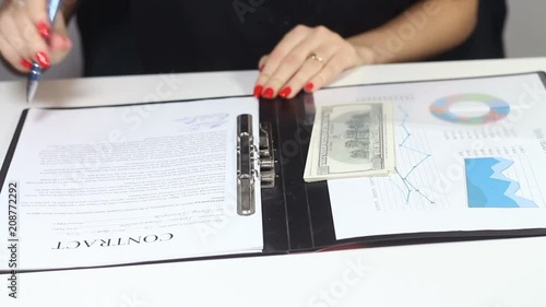 girl is studying the contract and counting the money