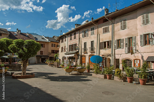 Square with stone building and shops in Conflans. An historical hamlet near Albertville. Located at the department of Haute-Savoie, southeastern France.