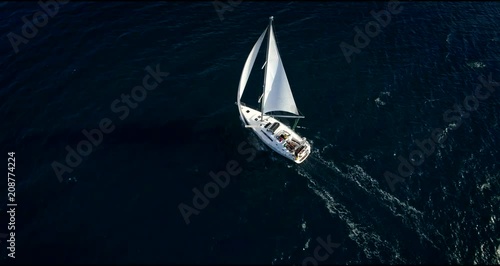 Yacht sailing at windy day. Freedom of Yachting at opened sea / ocean. Aerial, drone video.