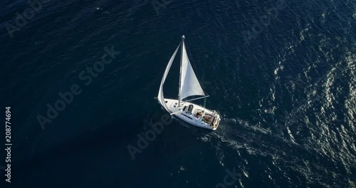 Yacht sailing at windy day. Freedom of Yachting at opened sea / ocean. Aerial, drone video.