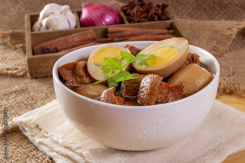 stewed eggs or eggs and pork in brown sauce by Thai food