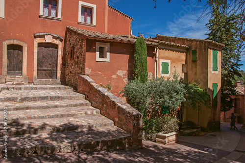 View of traditional colorful house in ocher and staircase, in the historic Roussillon. Located in the Vaucluse department, Provence region, southeastern France.