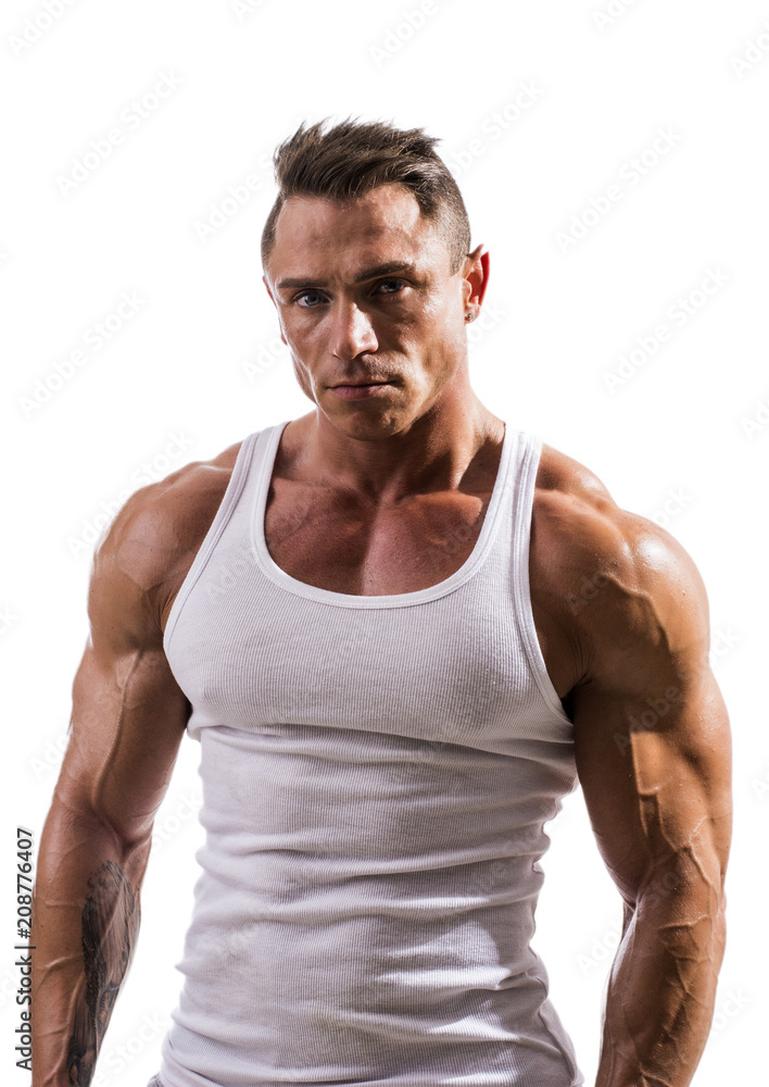 Handsome athletic muscle man in white tank top shirt isolated on white,  looking at camera Stock Photo
