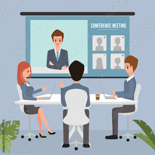 Business people looking at screen during video conference in office.