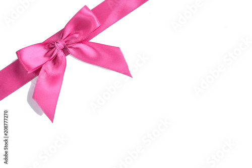 Pink satin ribbon bow isolated on white background. © Natallia