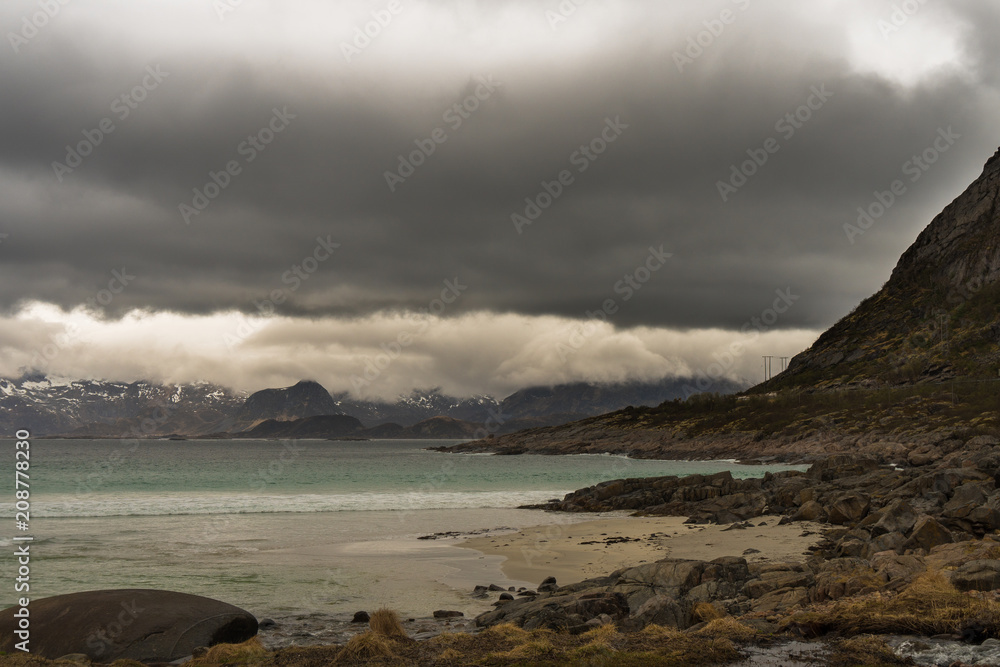 Rorvikstranda beach and Gimsoystraumen fjord near Henningsvaer at Lofoten Islands / Norway at a rainy day