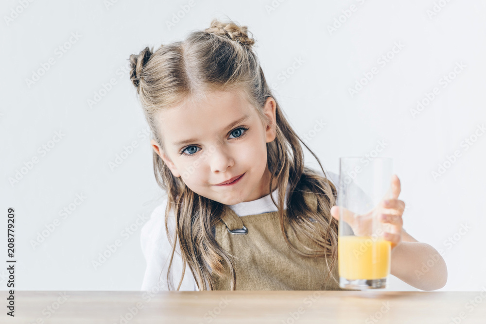 adorable little schoolgirl with glass of orange juice isolated on white adorable little schoolgirl with glass of orange juice isolated on white