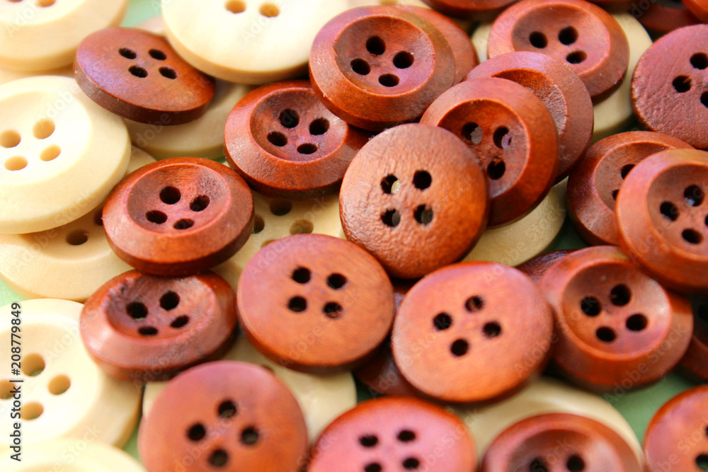 Wooden Craft Buttons on a wooden background. Wooden Craft Buttons on a wooden background.