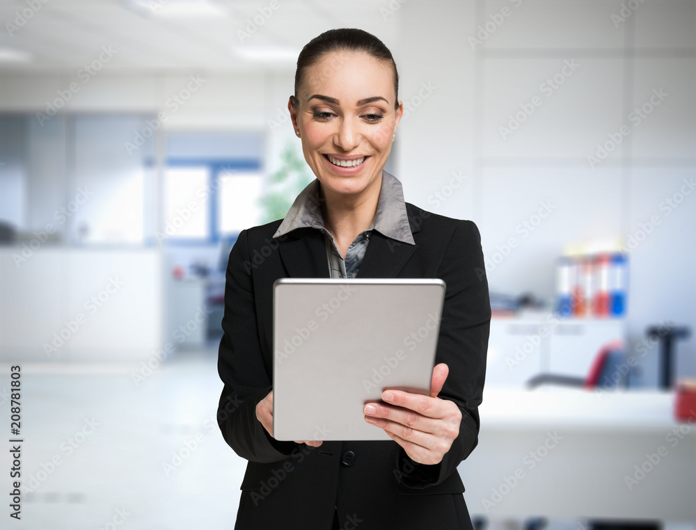Woman using a tablet in her office Woman using a tablet in her office