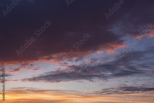 Colorful clouds on evening sky at sunset background.
