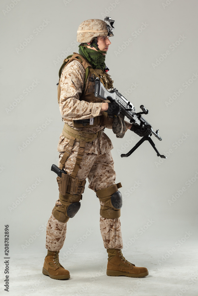 Soldier in camouflage holding rifle Soldier in camouflage holding rifle