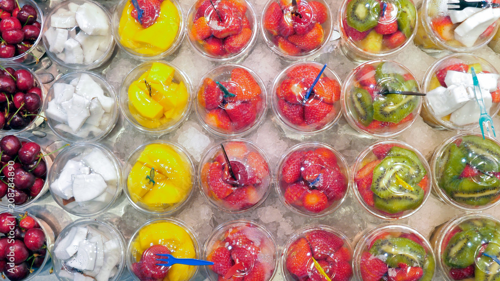 Fresh squeezed fruit juice in plastic cups at La Boqueria market, Barcelona Fresh squeezed fruit juice in plastic cups at La Boqueria market, Barcelona