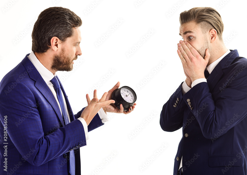 Businessman in classic suit holds clock in hand Businessman in classic suit holds clock in hand