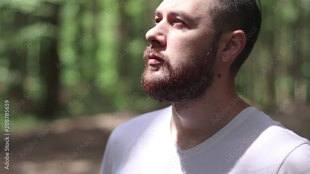 Portrait of a beard man praying. Looking up to the sky in outdoors. Lips moving Portrait of a beard man praying. Looking up to the sky in outdoors. Lips moving