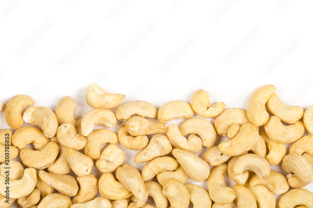 Border of raw, organic, whole cashew nut kernels over white Border of raw, organic, whole cashew nut kernels over white