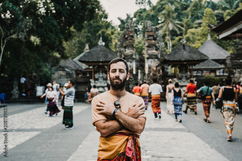 .Young and cheerful tourist enjoying the island of Bali in Indonesia. Knowing ancient Hindu temples, very spiritual places. Travel Photography. Lifestyle..
