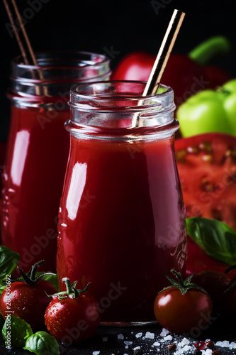 Wallpaper Mural Spicy tomato juice with chili, bell peppers and green basil in glass bottles on black background, selective focus Torontodigital.ca