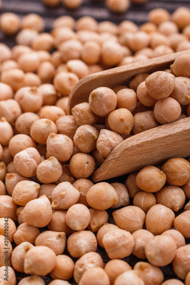uncooked chickpeas on a wooden rustic background uncooked chickpeas on a wooden rustic background