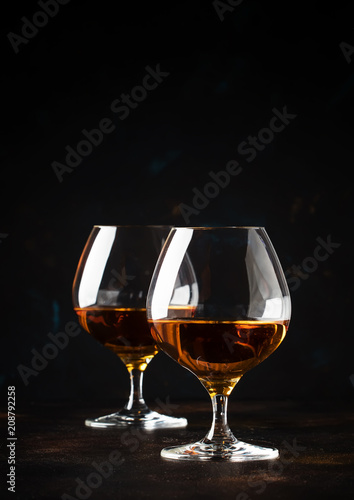 Cognac in a glass, dark background, selective focus