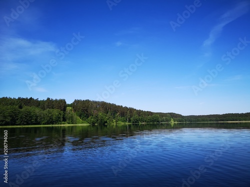 A hill near a blue clear lake