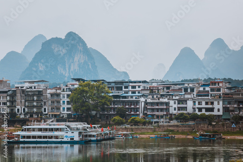 Scenic landscape at Yangshuo County of Guilin. Li River (Lijiang River). Pleasure boats at the pier in Yangshuo Town, China.