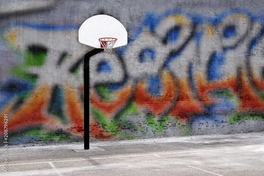 Naklejka premium Urban basketball hoop inner city innercity wall and asphalt in outdoor park