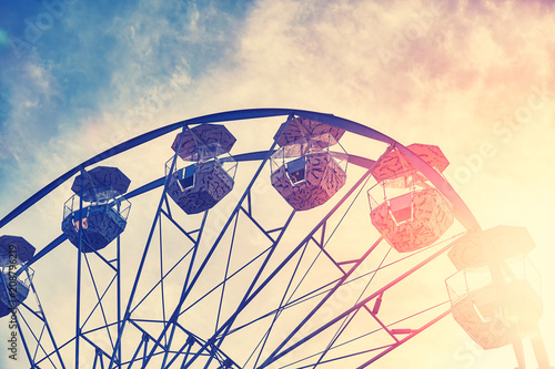 Vintage toned picture of a Ferris wheel at sunset.