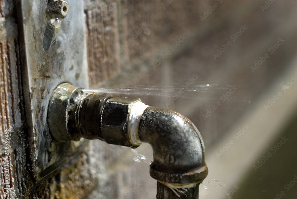 Leaky Pipe with Water Spraying Squirting Out Leaky Pipe with Water Spraying Squirting Out
