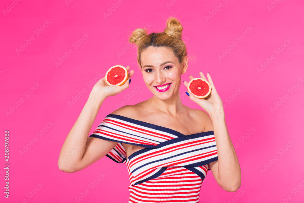 Portrait of happy girl holding halves of orange near face Portrait of happy girl holding halves of orange near face