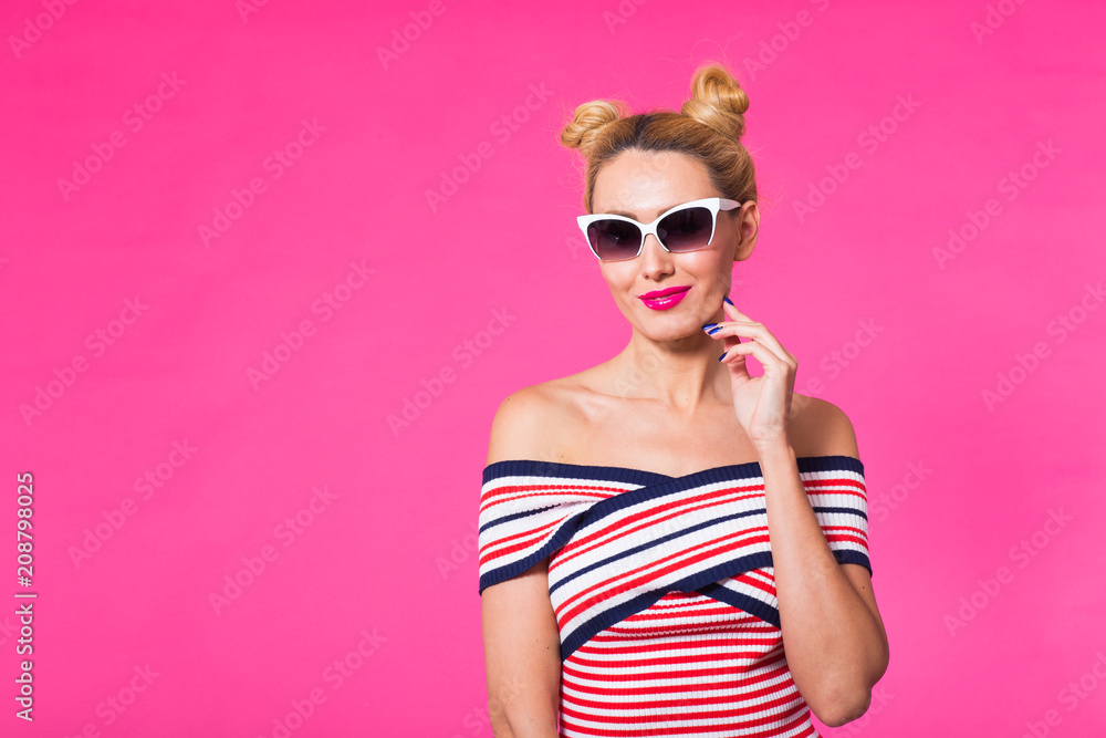 Fashion studio portrait of glamour girl, cute emotions, stylish hipster clothes sunglasses on pink background with copyspace Fashion studio portrait of glamour girl, cute emotions, stylish hipster clothes sunglasses on pink background with copyspace