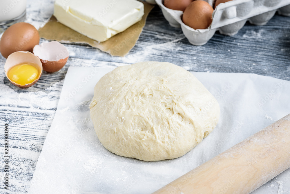 Dough mixing recipe bread, pizza or pie making ingridients, food flat lay on kitchen table background. Working with butter, milk, flour, eggs, sugar or bakery cooking. Dough mixing recipe bread, pizza or pie making ingridients, food flat lay on kitchen table background. Working with butter, milk, flour, eggs, sugar or bakery cooking.