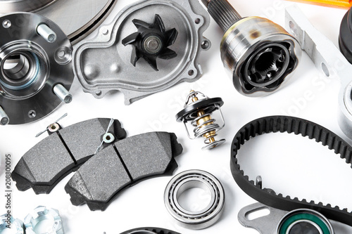 Auto parts background. Hub, pump, brake pads, filter, timing belt, rollers, constant velocity joints, thermostat and other on white background photo