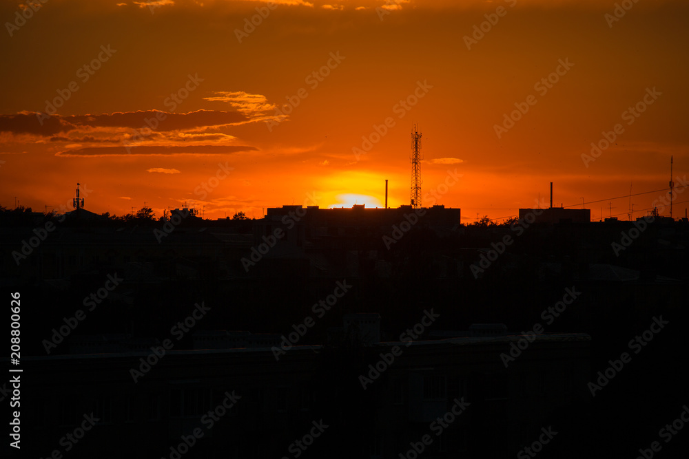 Sunset in the city with cellular tower