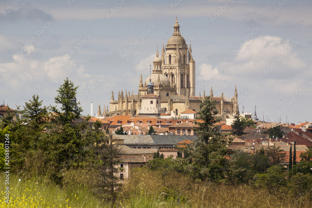 Photograph of monumental Segovia. Cathedral, aqueduct and historical center. Trees and plants in the spring season. Segovia, Castilla y Leon. Spain, Europe.
