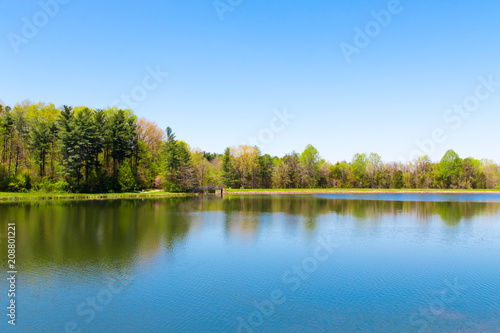 Fototapeta Naklejka Na Ścianę i Meble -  Beautiful lake with forest reflection on sunny spring day.