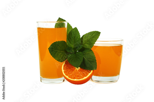 Fresh orange juice with mint in a glass cup isolated on white background. Fresh oranges and juice on a white background, view of the shu, cospore space.