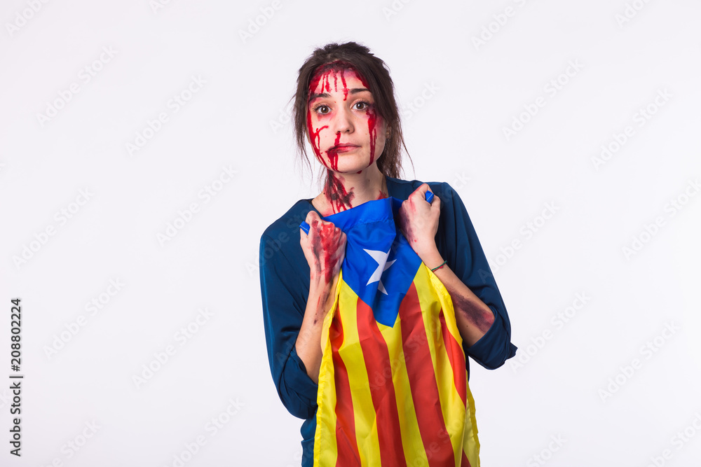 Portrait young catalan victim woman holding flag of catalonia isolated on white background with copyspace. Protest against terrorism.
