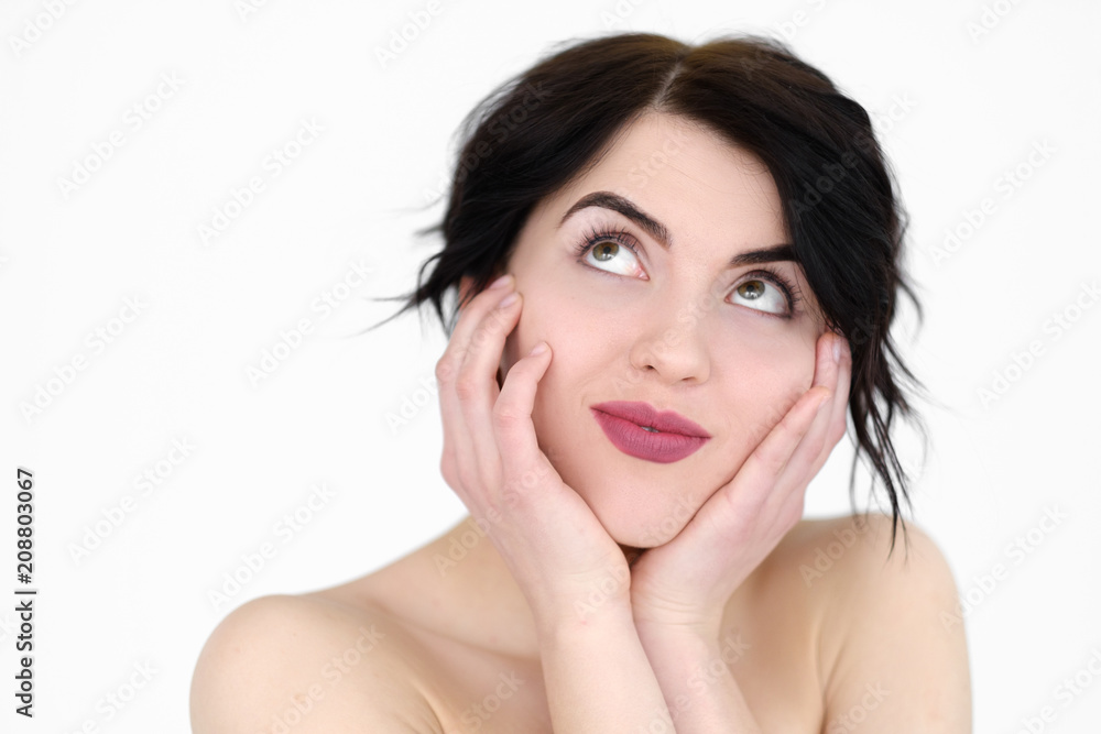 emotion face. happy smiling romantic woman holding head in hands and looking up. young beautiful brunette girl portrait on white background. emotion face. happy smiling romantic woman holding head in hands and looking up. young beautiful brunette girl portrait on white background.