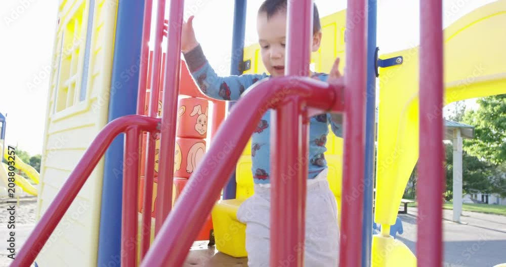 Toddler boy running towards camera on play structure - slow motion Toddler boy running towards camera on play structure - slow motion