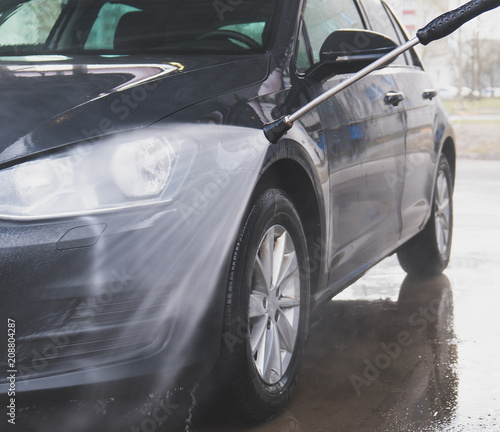 Car wash using high pressure water jet. © M-Production
