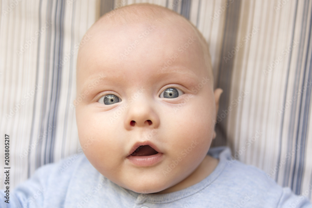 Portrait of a cute surprised baby in blue clothes Portrait of a cute surprised baby in blue clothes
