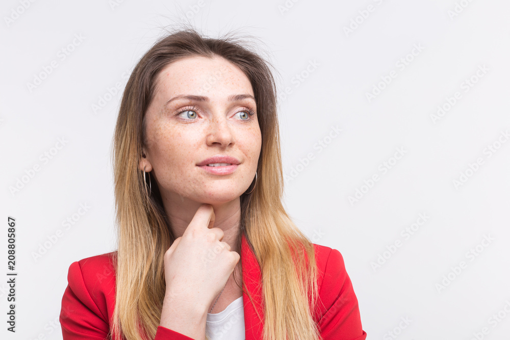 Smiling freckled beautiful woman with hand on her chin Smiling freckled beautiful woman with hand on her chin